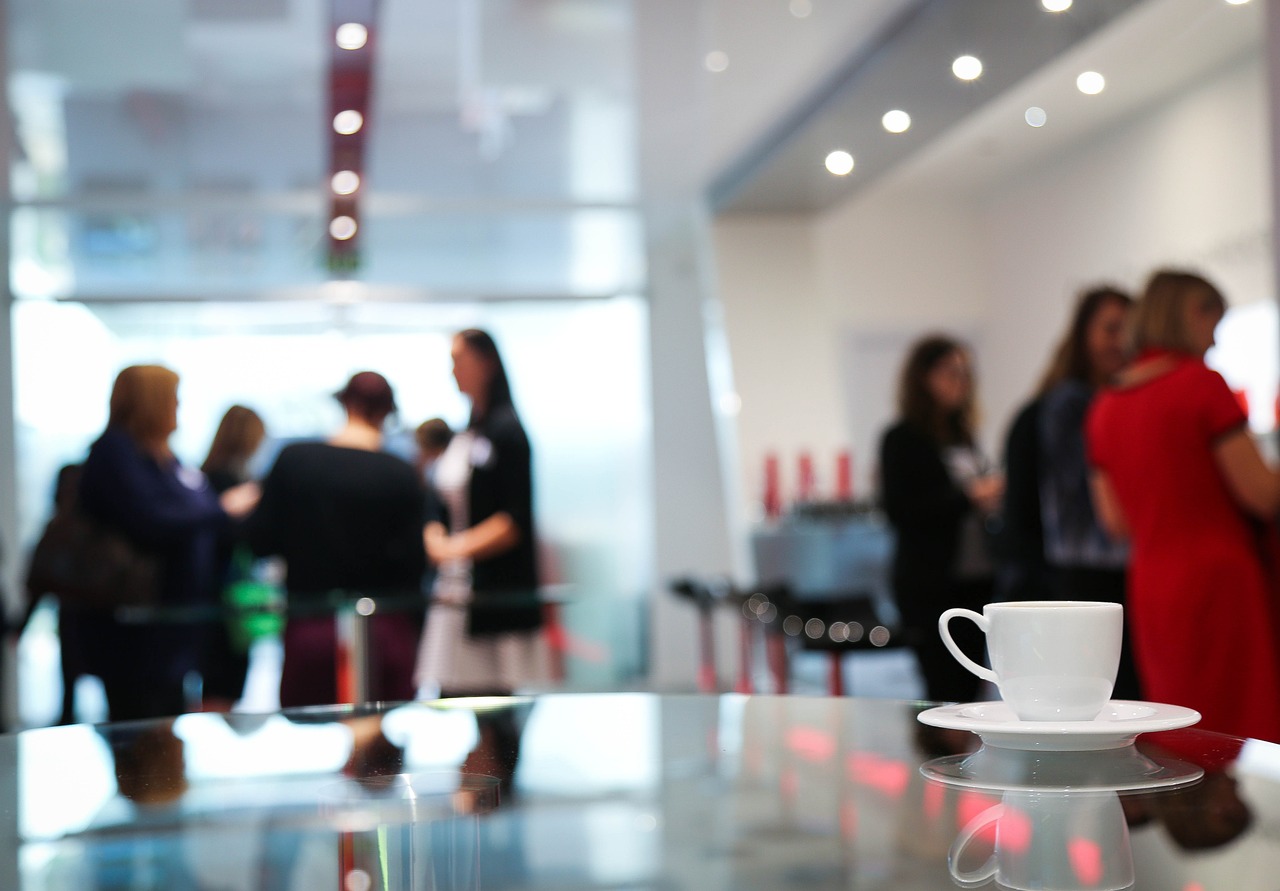 Coffee cup on table with people in background