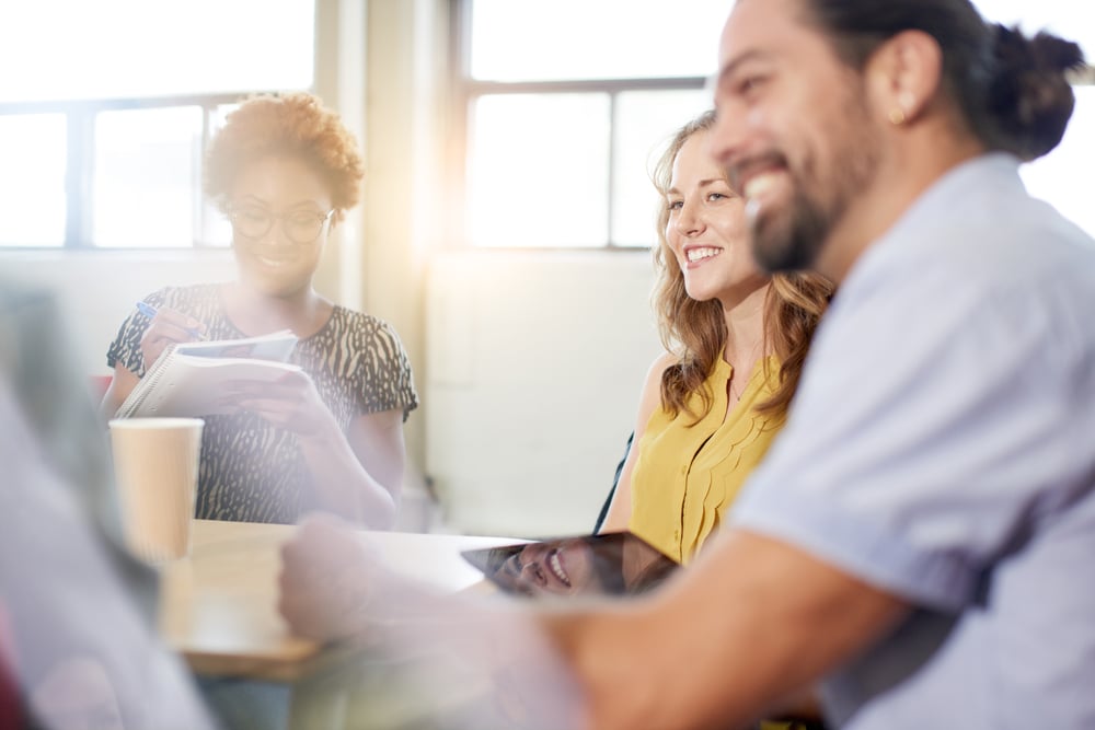 Unposed group of creative business people in an open concept office brainstorming their next project