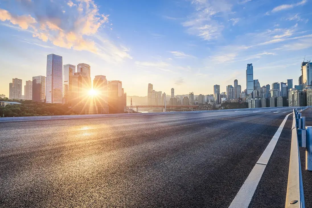 Sun rising behind city skyline